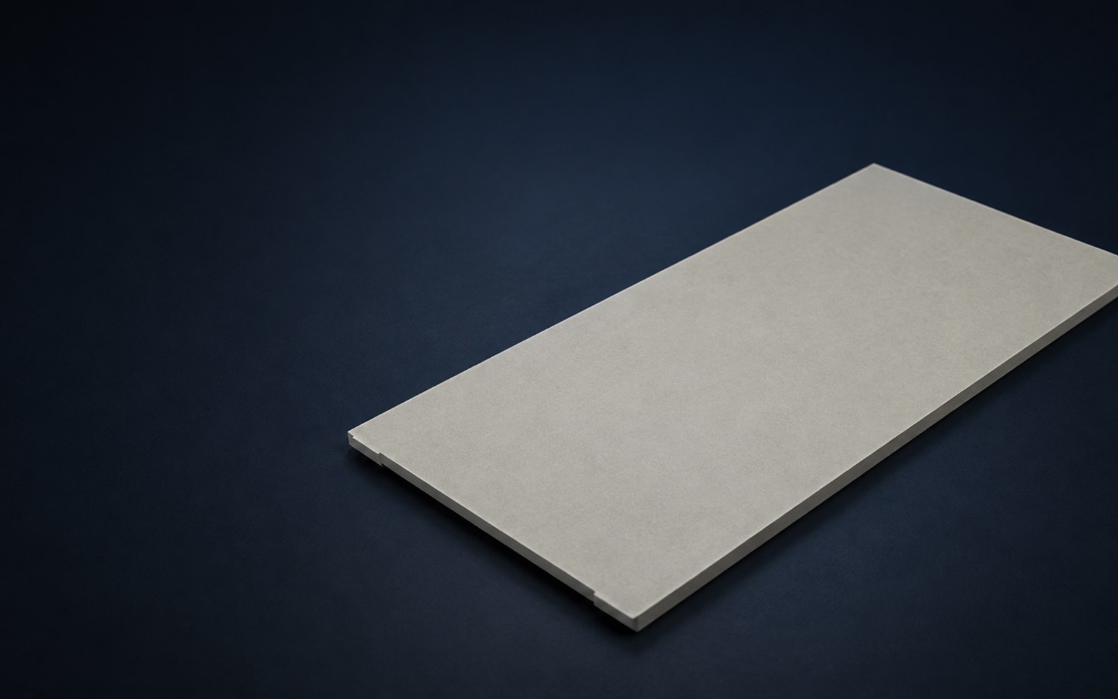 Flat ACFoam polyiso insulation board showing uniform thickness and a tongue-and-groove edge detail on a dark background